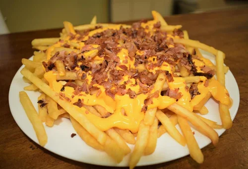 Papas fritas con cheddar y panceta